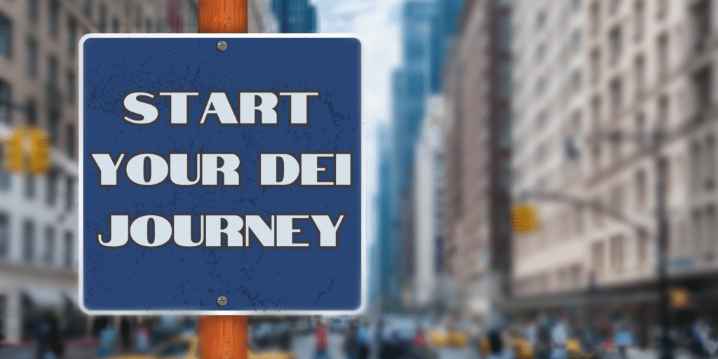 A view of the busy road with buildings all around and the sign board stating "Start your DEI journey"