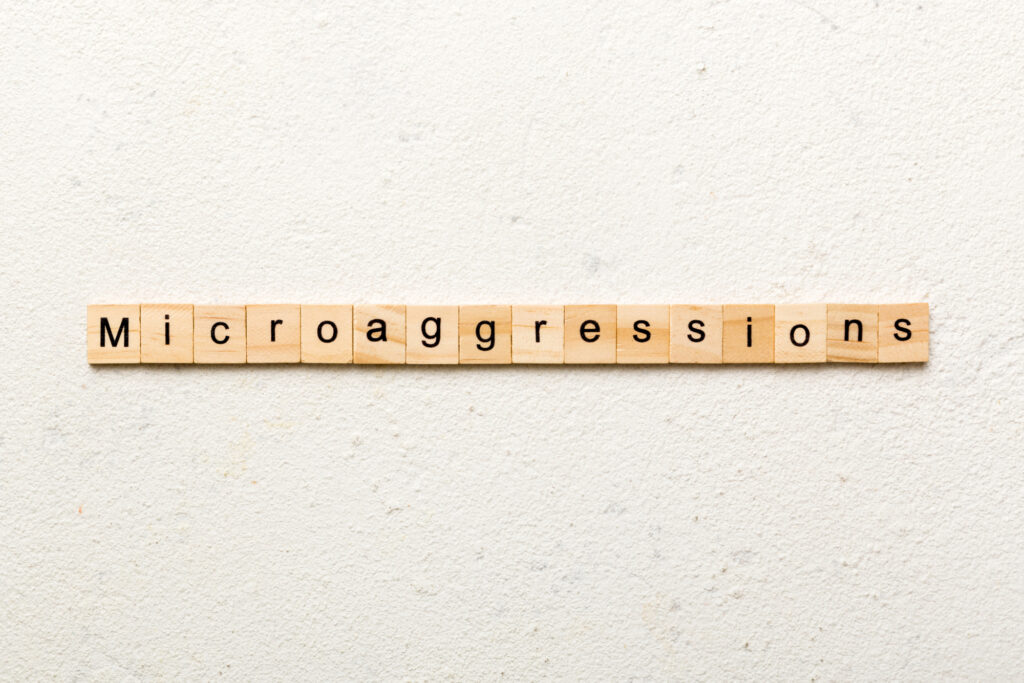 Microaggressions word written on wood block.