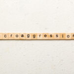 Microaggressions word written on wood block.