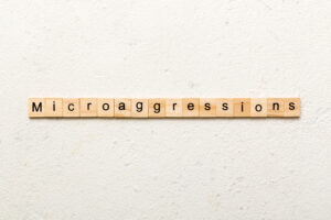 Microaggressions word written on wood block.